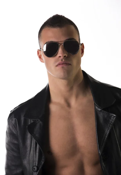Attractive young man shirtless, wearing black leather trench — Stock Photo, Image