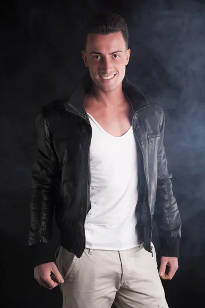 Smiling young man with white t-shirt and leather jacket — Stock Photo, Image