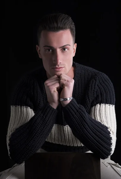 Good looking young man sitting, wearing winter sweater — Stock Photo, Image