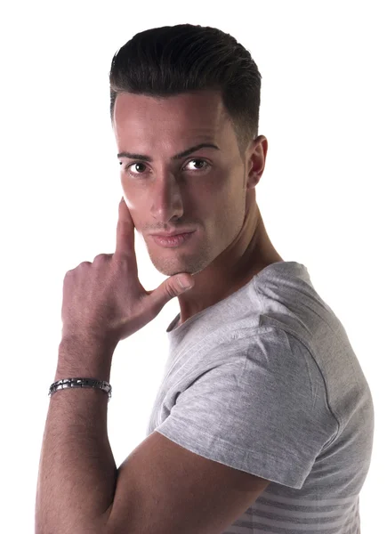 Handsome young man looking at camera, hand on his chin — Stock Photo, Image