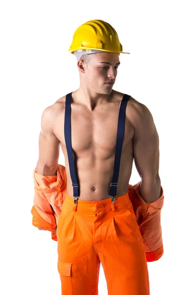 Handsome athletic young construction worker taking off orange suit — Stock Photo, Image