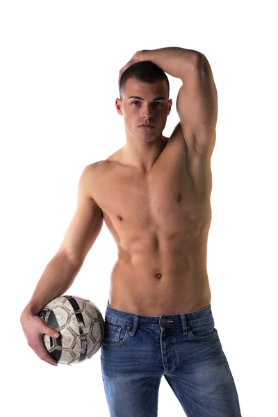 Shirtless football (soccer) player in jeans with ball standing — Stok Foto