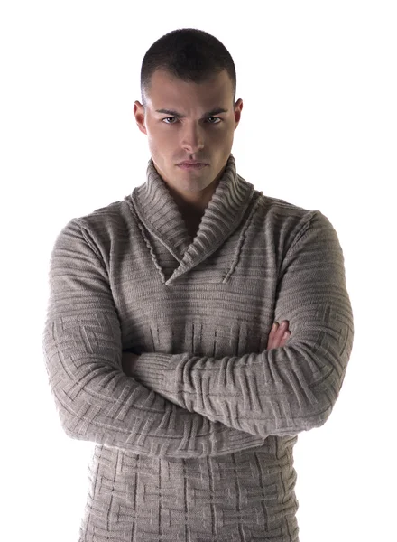 Attractive young man with stern, severe expression, arms crossed on chest — Stock Photo, Image