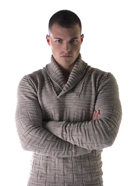 Attractive young man with stern, severe expression, arms crossed on chest — Stok Foto