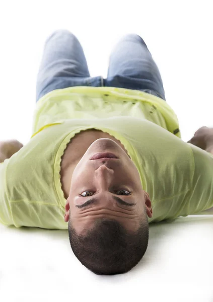 Handsome young man laying on the floor, belly up — Stock Photo, Image