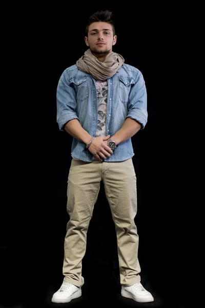 Full length body shot of young man standing on black background — Stock Photo, Image