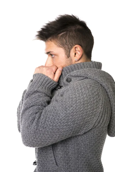 Profil mladého muže na sobě svetr pokrývající ústa rukama — Stock fotografie