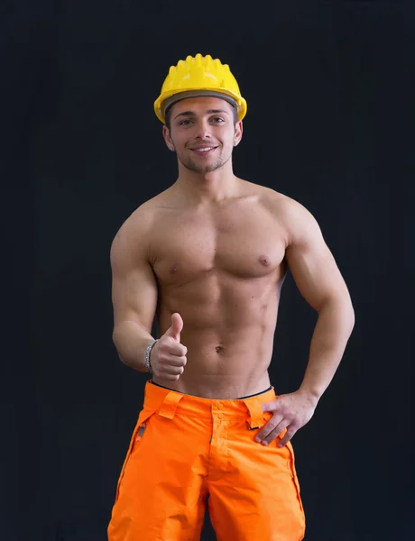 Muscular young construction worker doing thumb up sign for OK — Stock Photo, Image