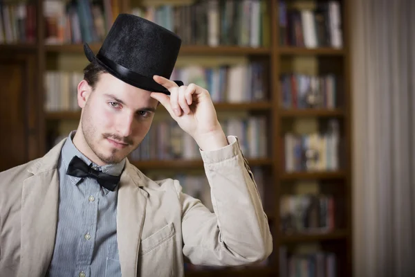 Elegant young man wearing top hat and bow tie — Stock Photo, Image