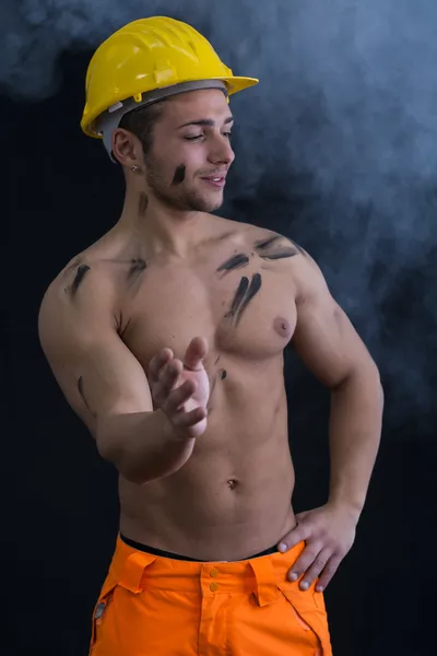 Muscular young construction worker shirtless with smoke around — Stock Photo, Image