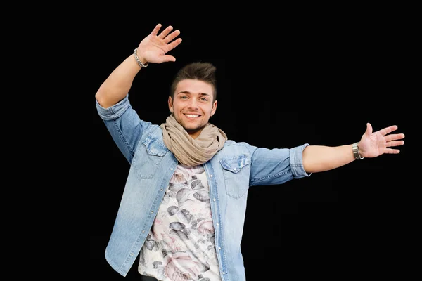 Cheerful young man dancing, moving arms up in the air — Stock Photo, Image