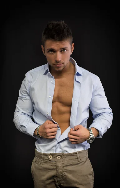 Attractive young man with open shirt on muscular torso — Stock Photo, Image