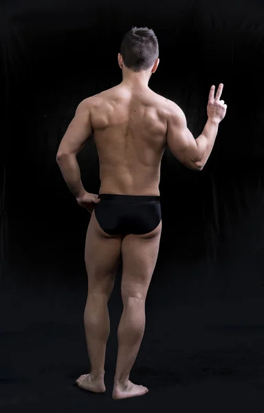 Full body shot of muscular young man seen from the back — Stock Photo, Image