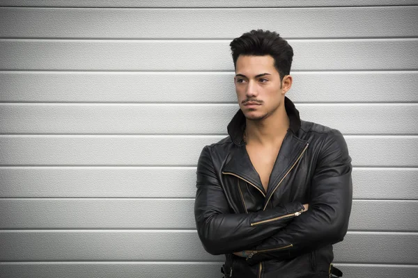 Young man with black leather jacket, arms crossed — Stock Photo, Image