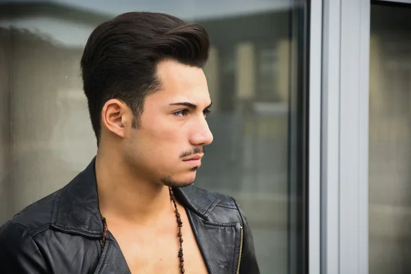 Handsome young man with leather jacket looking away — Stock Photo, Image