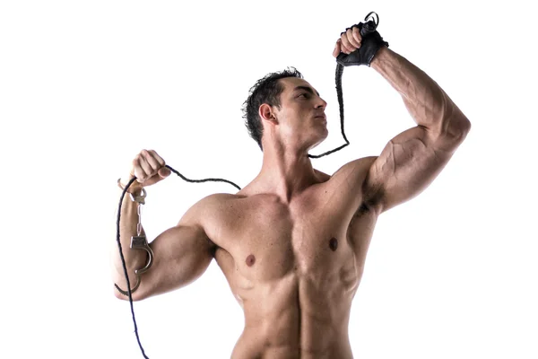 Muscular shirtless young man with handcuffs, whip and glove — Stock Photo, Image