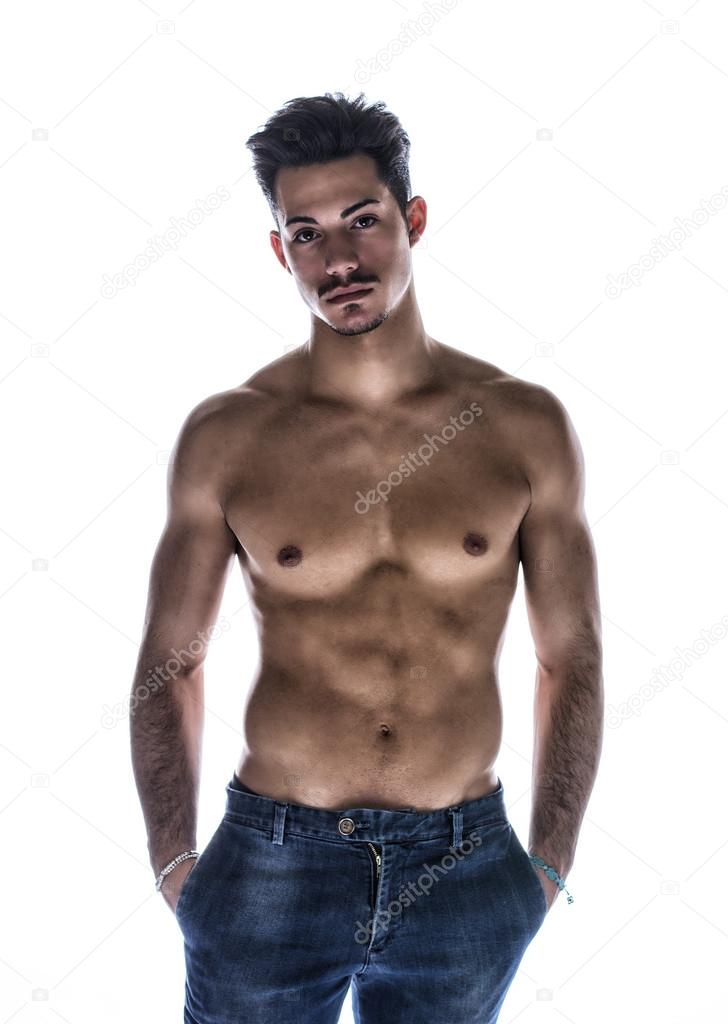 Athletic shirtless young man in jeans, with mustache