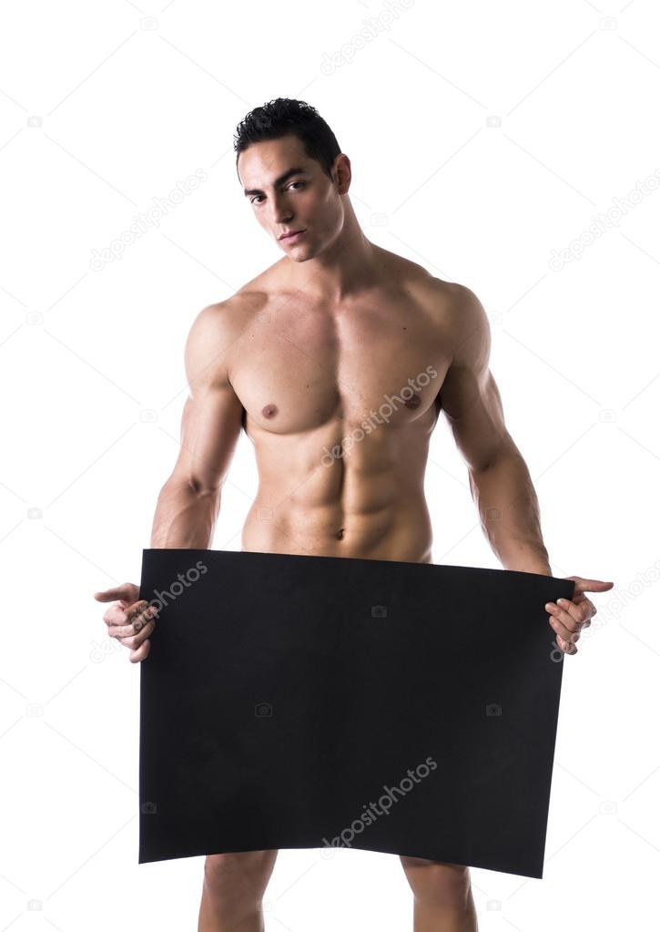 Naked young male bodybuilder holding blank board