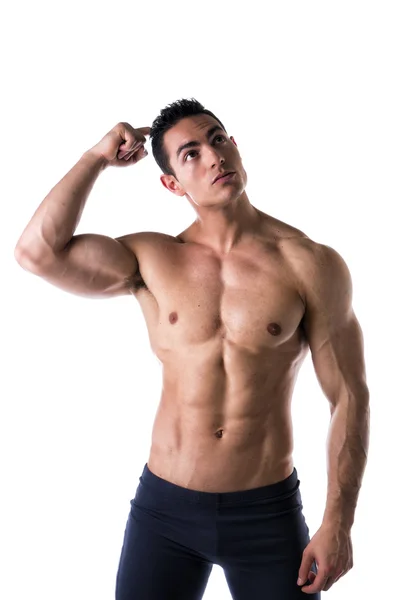 Muscular young man unsure or confused, scratching head — Stock Photo, Image