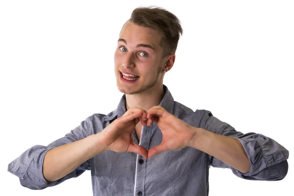 Hombre joven rubio feliz haciendo el signo de corazón o amor con las manos —  Fotos de Stock