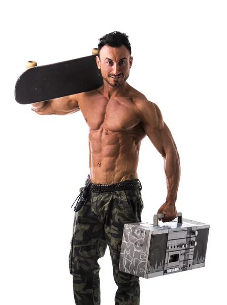 Shirtless muscular man with skateboard and boombox radio — Stock Photo, Image