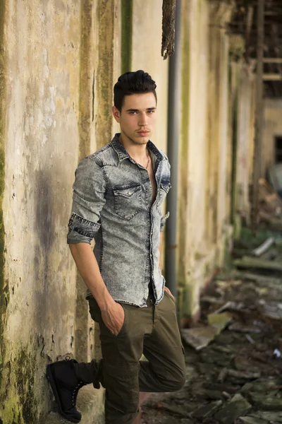 Joven guapo en abandonado, atropellado edificio — Foto de Stock