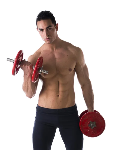 Muscular shirtless young man exercising biceps with dumbbells — Stock Photo, Image