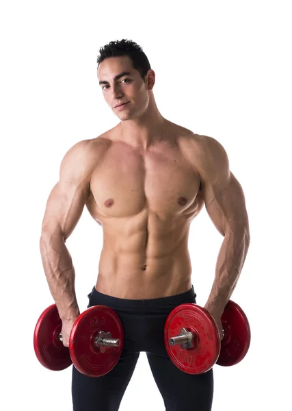 Happy muscular shirtless young man holding dumbbells — Zdjęcie stockowe