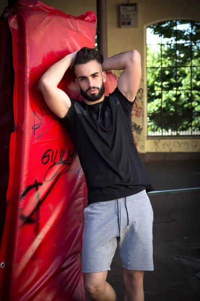 Handsome young man with beard, wearing t-shirt and shorts — Stock Photo, Image