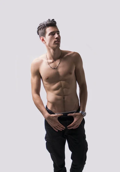 Lean athletic shirtless young man standing on light background — Stock Photo, Image