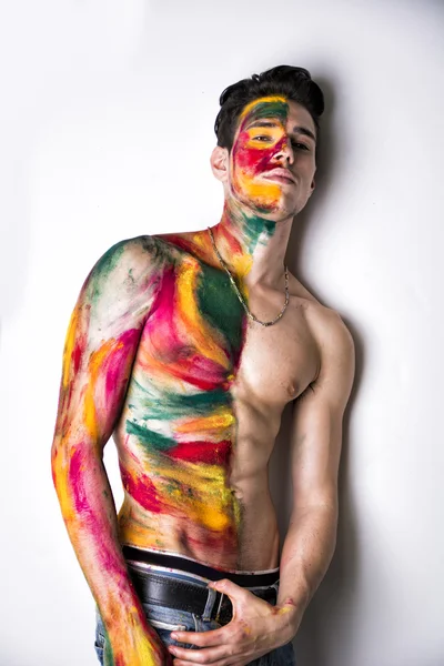 Hombre joven atractivo sin camisa, piel todo pintado con colores — Foto de Stock