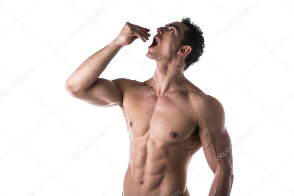 Strong muscular man taking diet supplements
