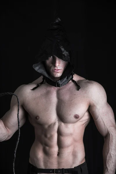 Muscular man with pointed hood — Stock Photo, Image