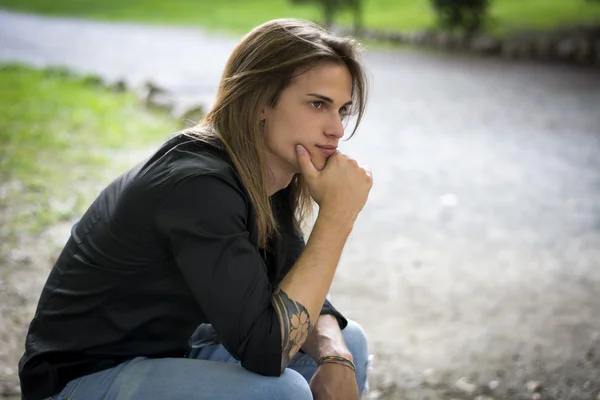 Long Hair Man sitting — Stock Photo, Image