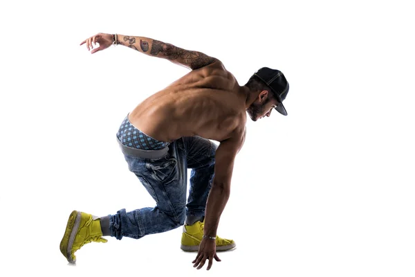 Young man in a hat doing a break dance — Stock Photo, Image