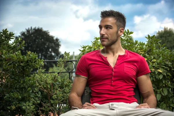 Fit male model sitting on bench — Stock Photo, Image