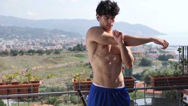 Athletic Attractive Shirtelss Young Man Exercising Stretching Outdoor Terrace Summer — Stockvideo