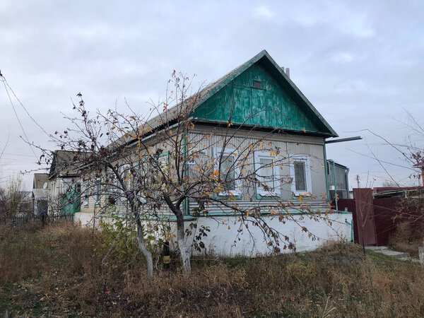 Wooden house with autumn tree