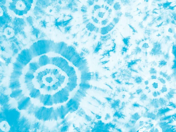 Tie dye shibori pattern. Abstract tie-dye technique hand dyed fabric. Turquoise blue teal ornamental circles elements on white background. Abstract texture.