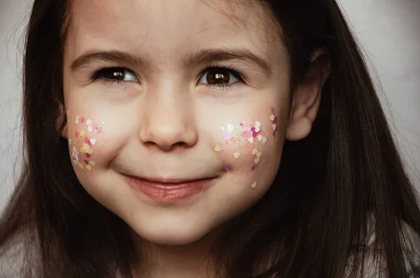 頬にスパンコールを持つ子供の女の子の肖像 — ストック写真