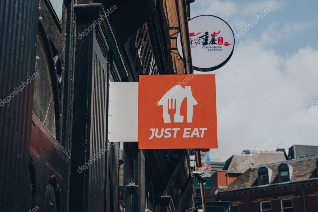 York, UK - June 22, 2021: Just Eat sign outside a restaurant in York. Just Eat is a company that enables food to be delivered from restaurants that do not offer delivery.
