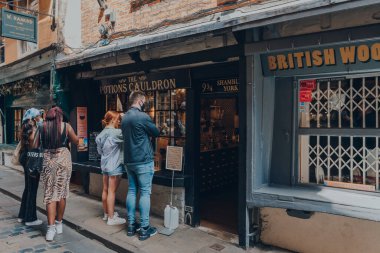York, UK - June 22, 2021: People outside The Potions Cauldron on Shambles, old street in York, England, with overhanging timber-framed buildings, some dating back as far as the fourteenth century. clipart