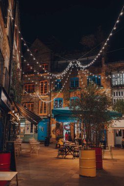 London, UK - November 23, 2021: Christmas lights in empt Neal's Yard in Covent Garden, a famous tourist area of London with lots of shops and restaurants.