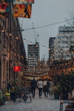 London, UK - January 01, 2022: People walking past the shops in Coal Drops Yard, a shopping destination and foodie hotspot near King's Cross St Pancras stations opened in 2018.