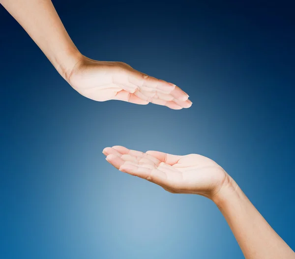 Hands of women isolated on blue background Royalty Free Stock Photos