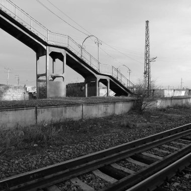 Black and white image of a bridge over the railway.