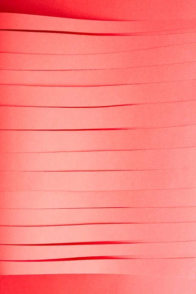 Red paper strips background. Simple concept with parallel paper strips.