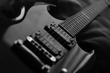 Black and white image of an electric guitar.