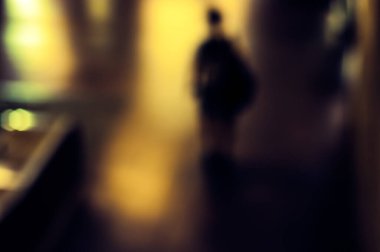 Blurry image of a young man in a subway.
