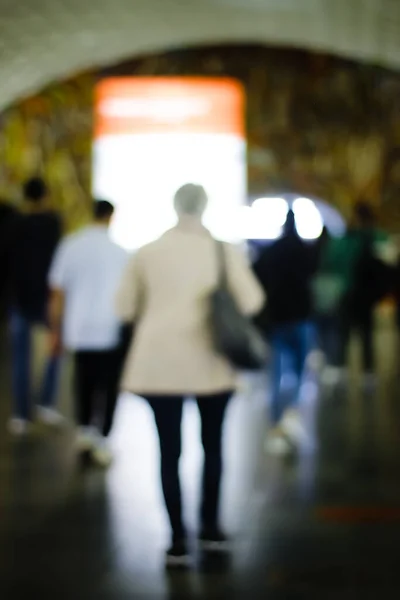 Lens blur image of subway with moving human silhouette.